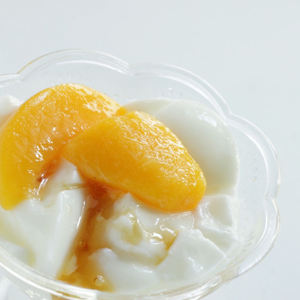 Canned food, cut mango and yogurt with copy space